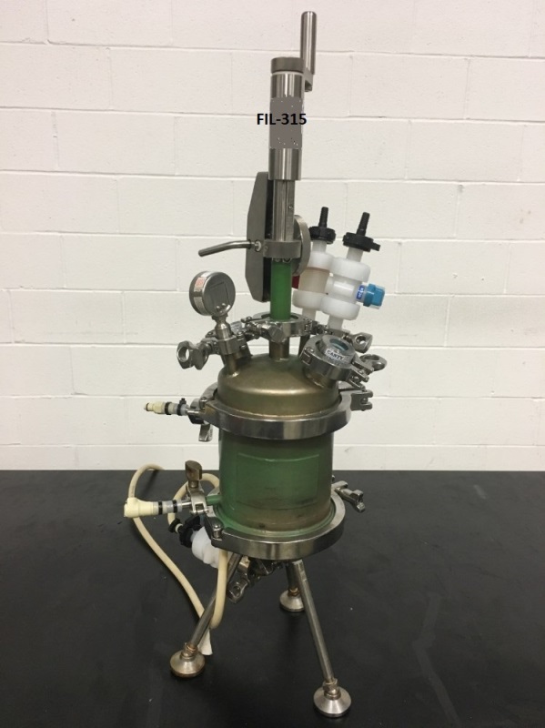 used Bench Top Pope Nutsche Filter Dryer. 1 Liter capacity. 316L Stainless Steel shell with Teflon lining rated 50/FV  @ 300 to (-20) Deg.F..  Jacket is 304L Stainless rated 50 PSI @ 300 Deg.F.. S/N 141407-1. Housing is 6